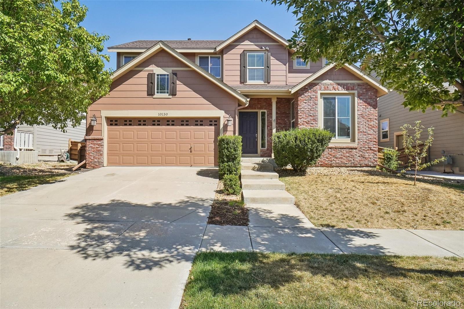 a front view of a house with a yard