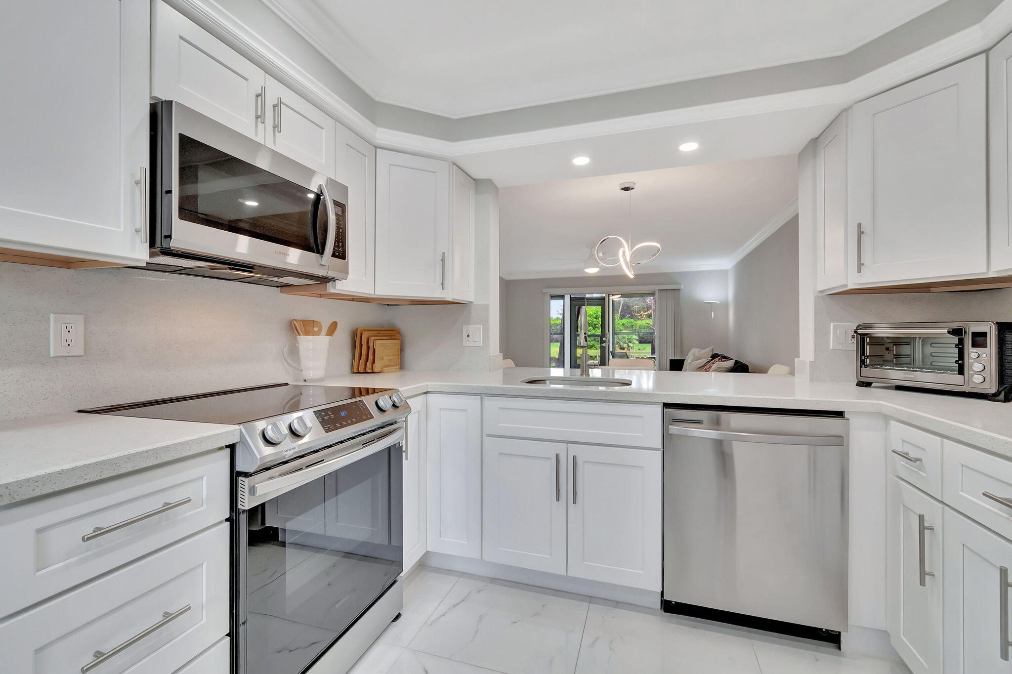 a kitchen with white cabinets appliances and sink