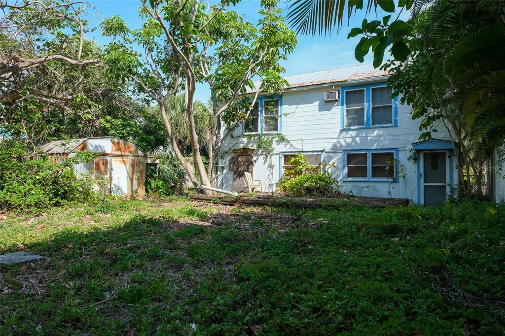 a view of a house with yard and a tree