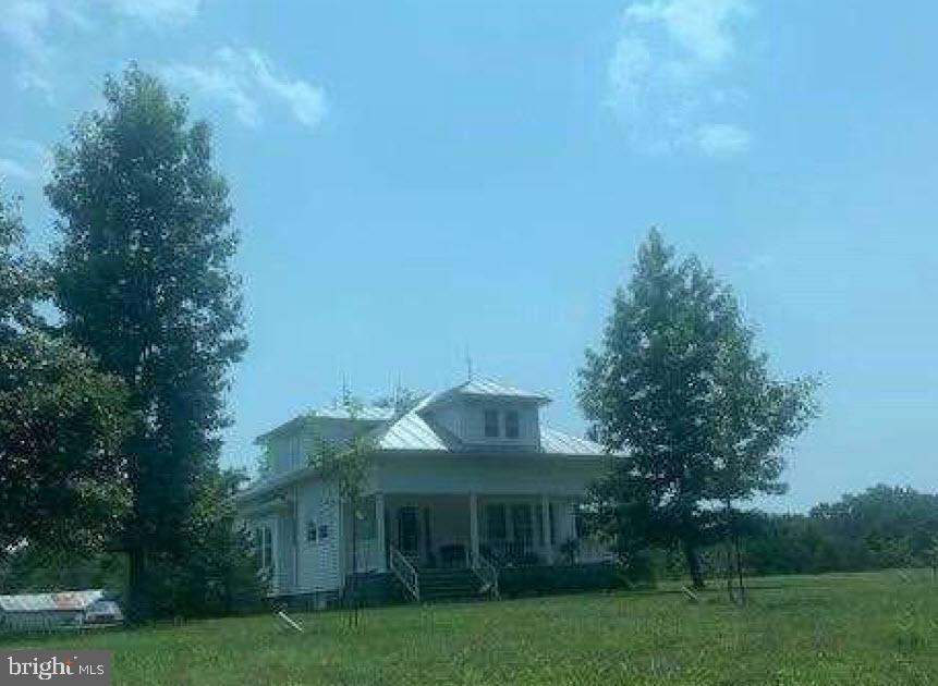 a view of house with outdoor space and garden