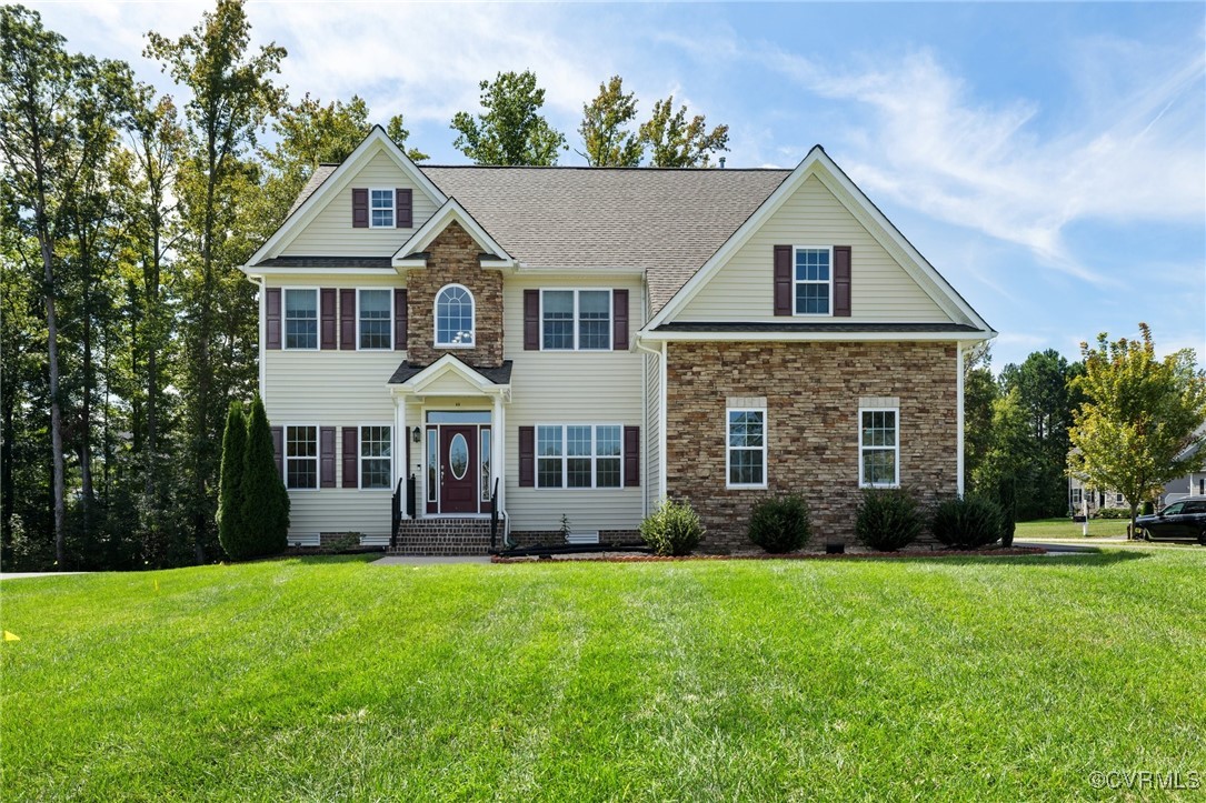 a front view of a house with garden