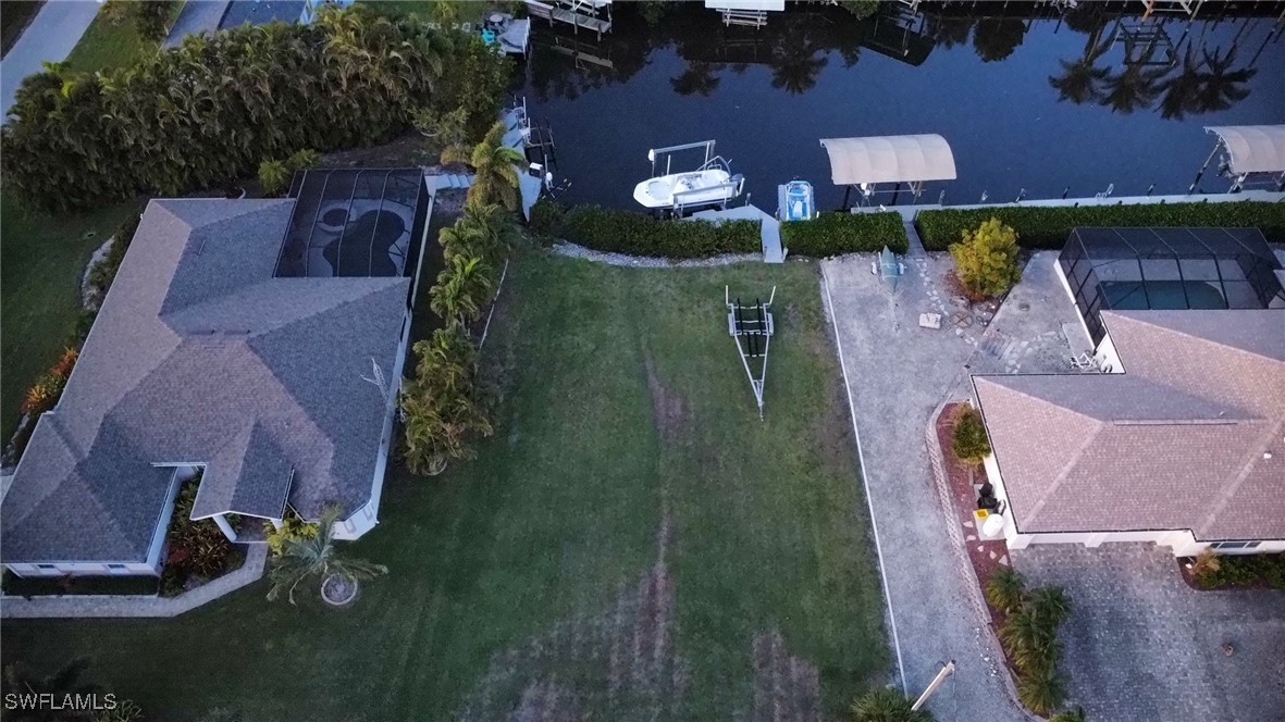 an aerial view of a house with a yard basket ball court and outdoor seating