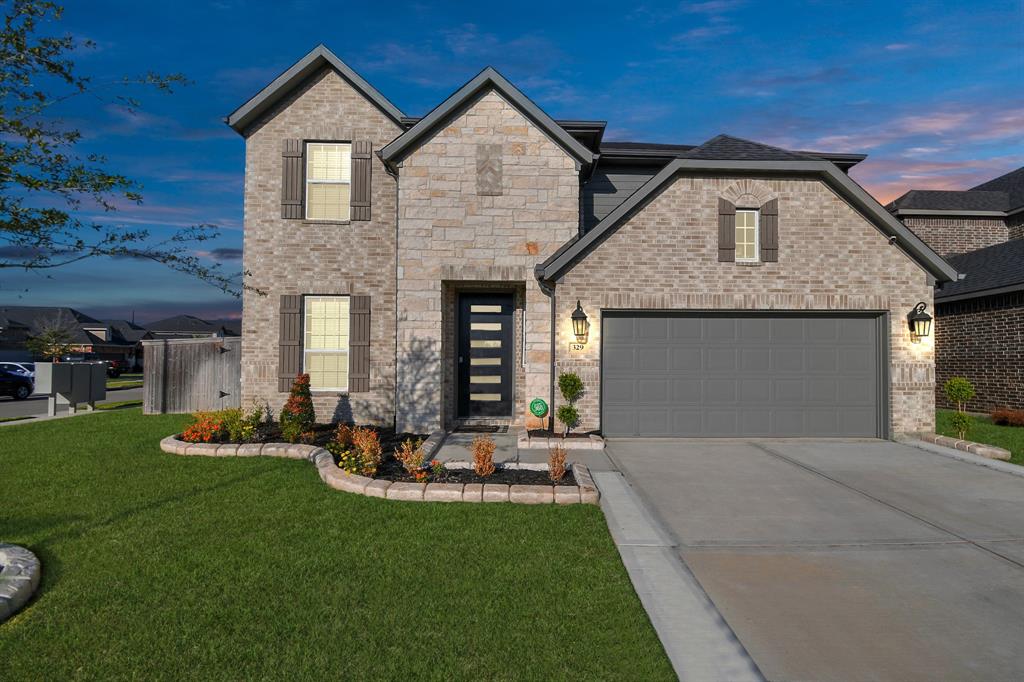 a front view of a house with a yard and garage