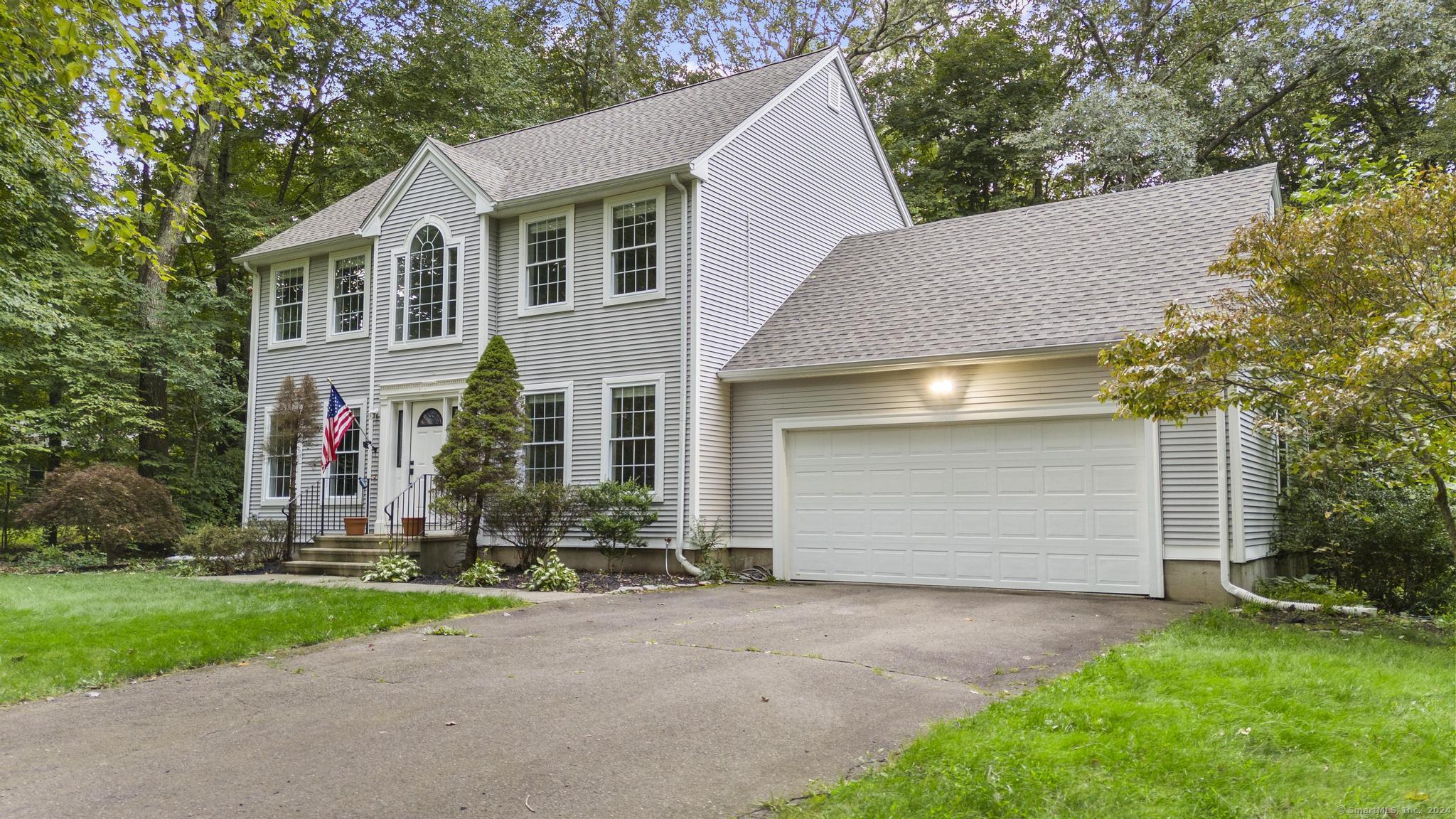 a front view of house with yard and green space