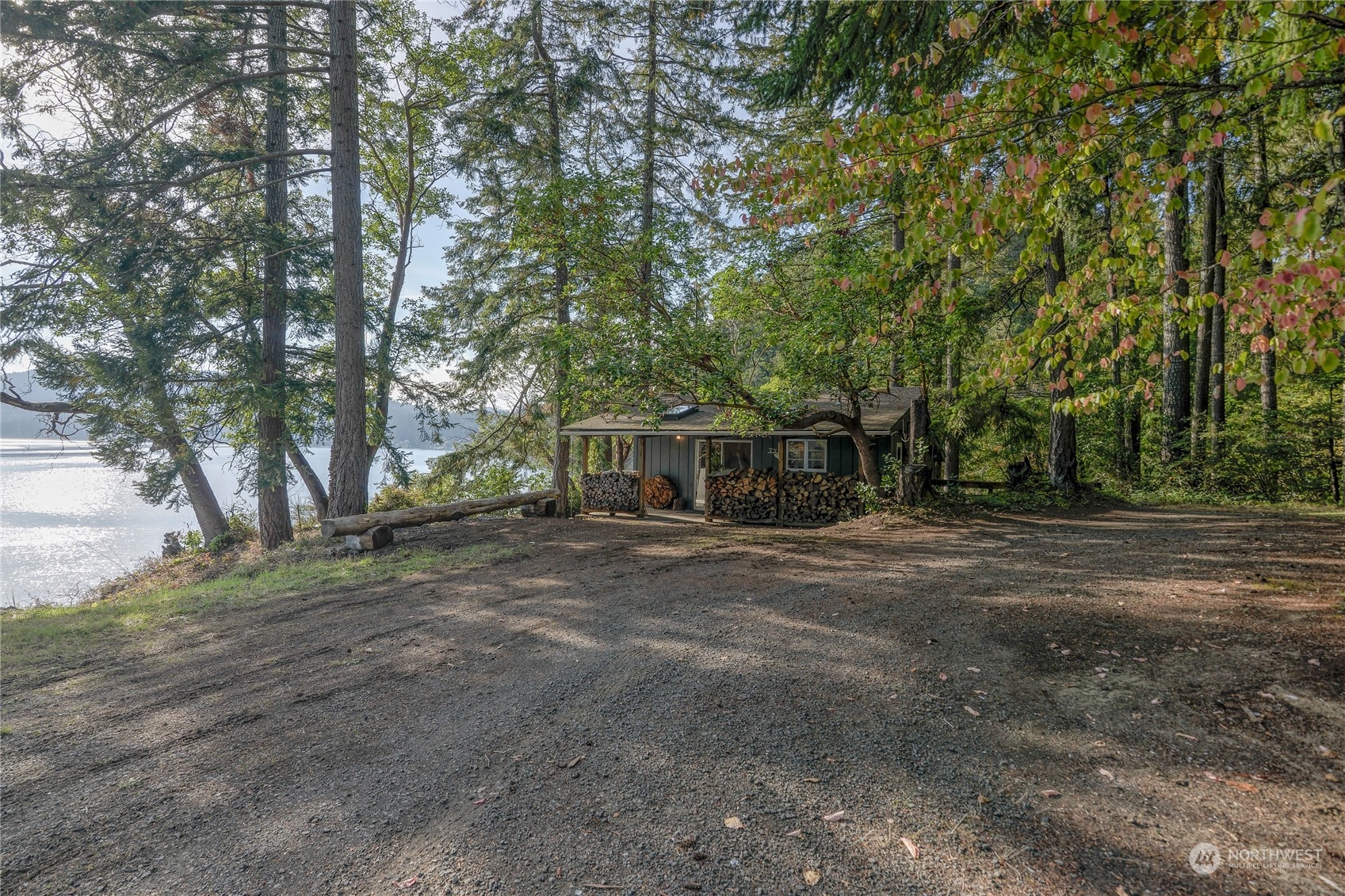 a view of a trees and barn in the middle of a yard