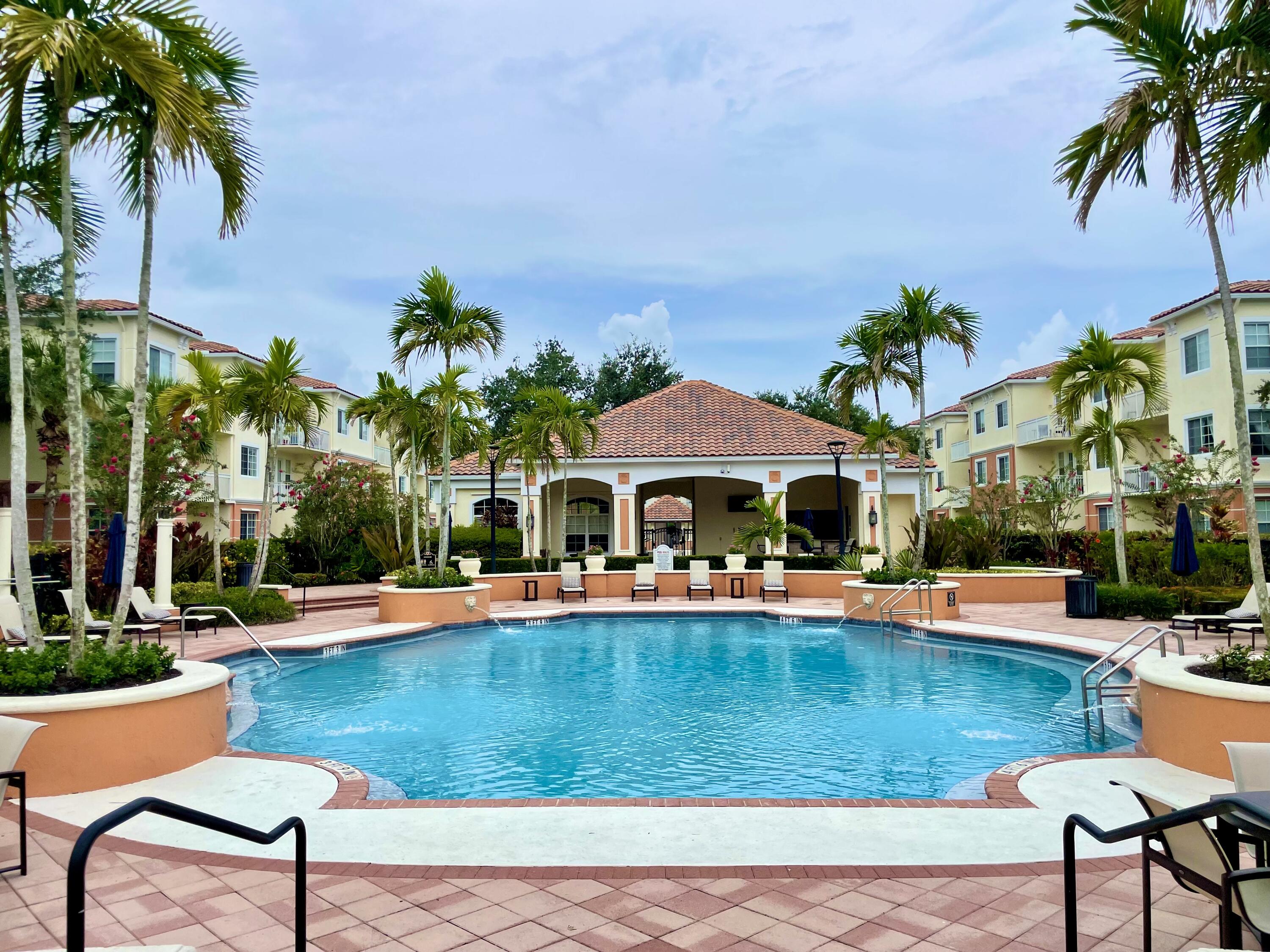 a view of a house with swimming pool and sitting area