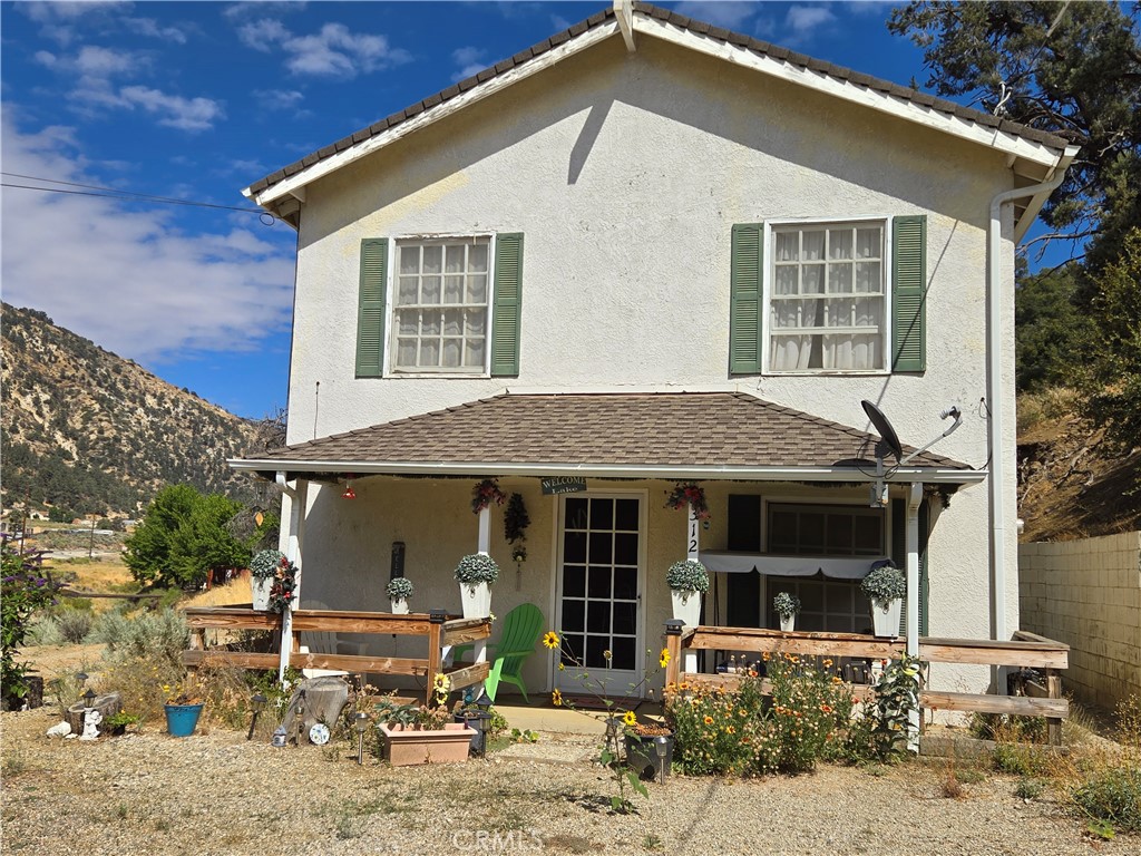 a front view of a house with table and chairs