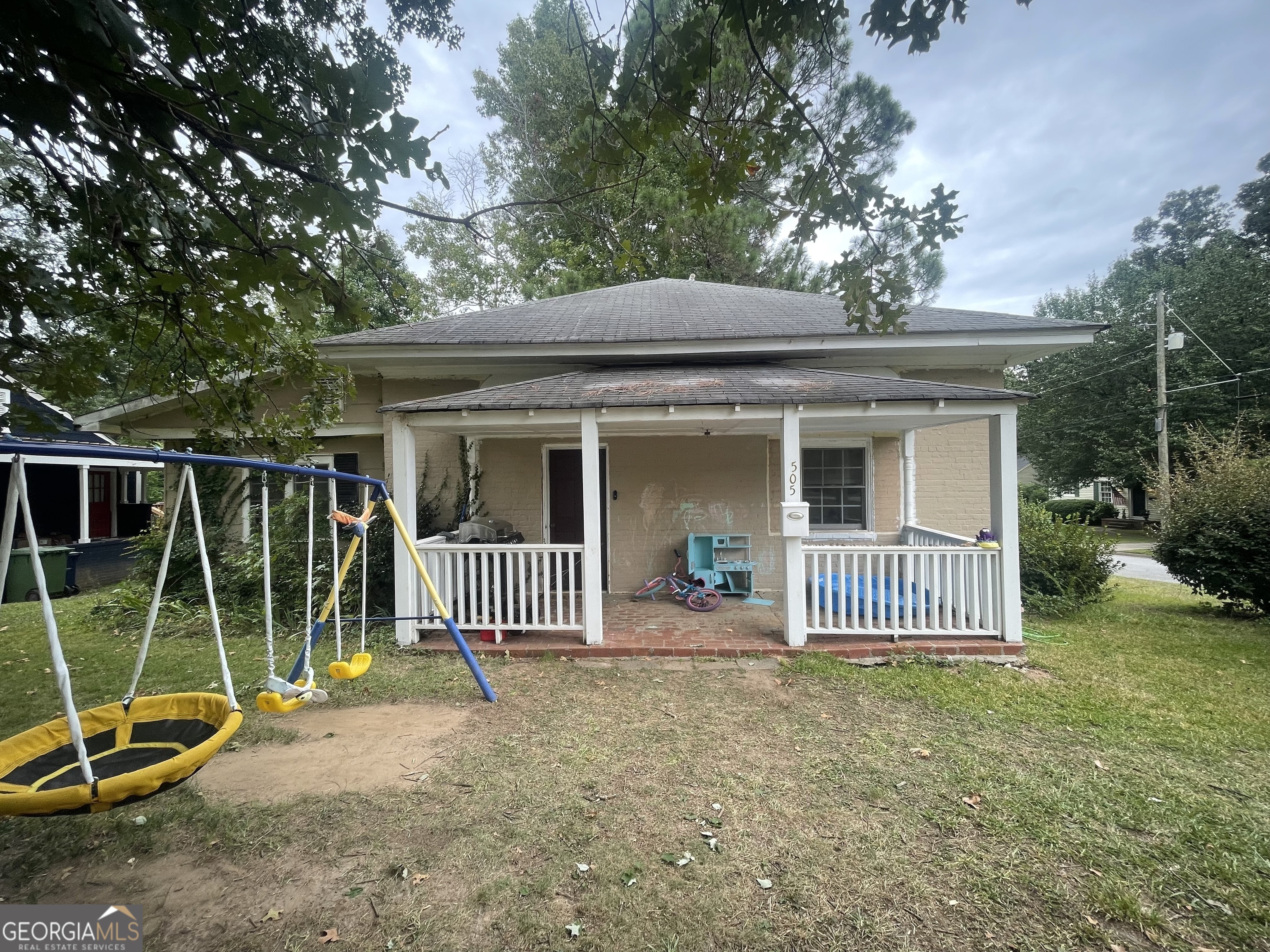 a view of a house with a backyard and a slide