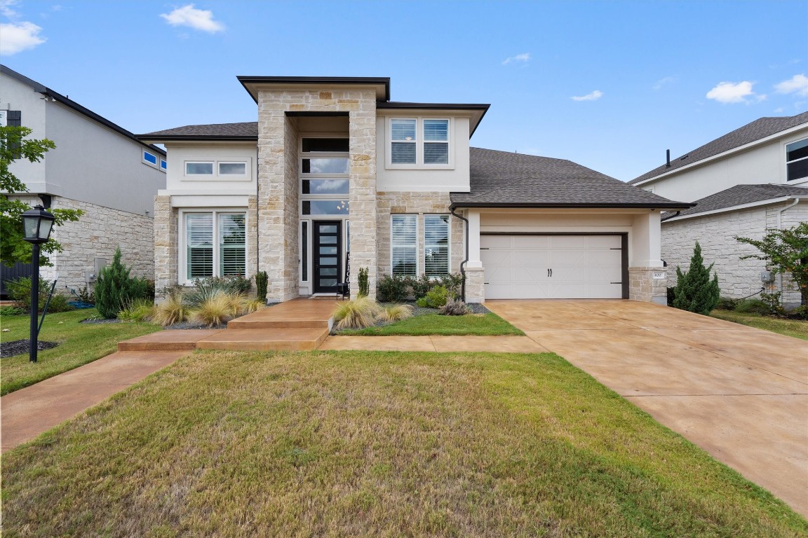 a view of a house with a yard and garage