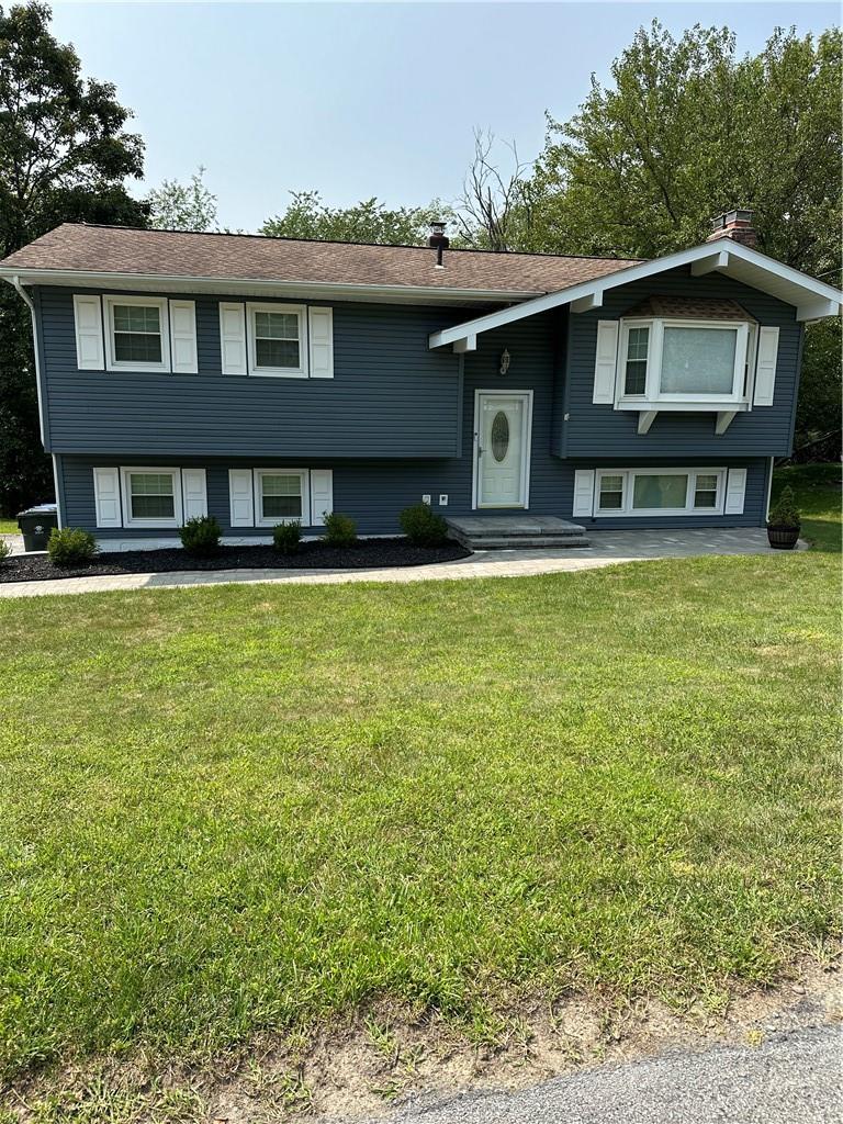 a front view of a house with yard