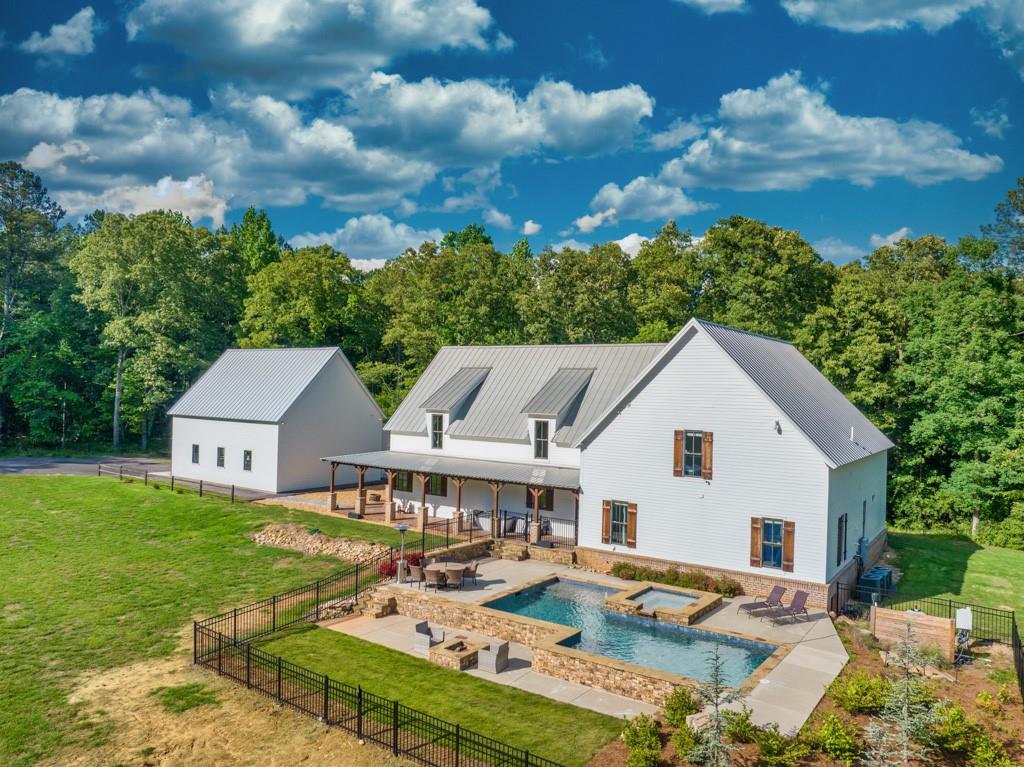 a aerial view of a house with swimming pool and furniture