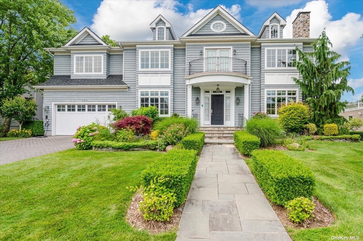 a front view of a house with garden