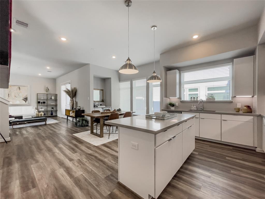 a kitchen with lots of counter top space and painting on the wall