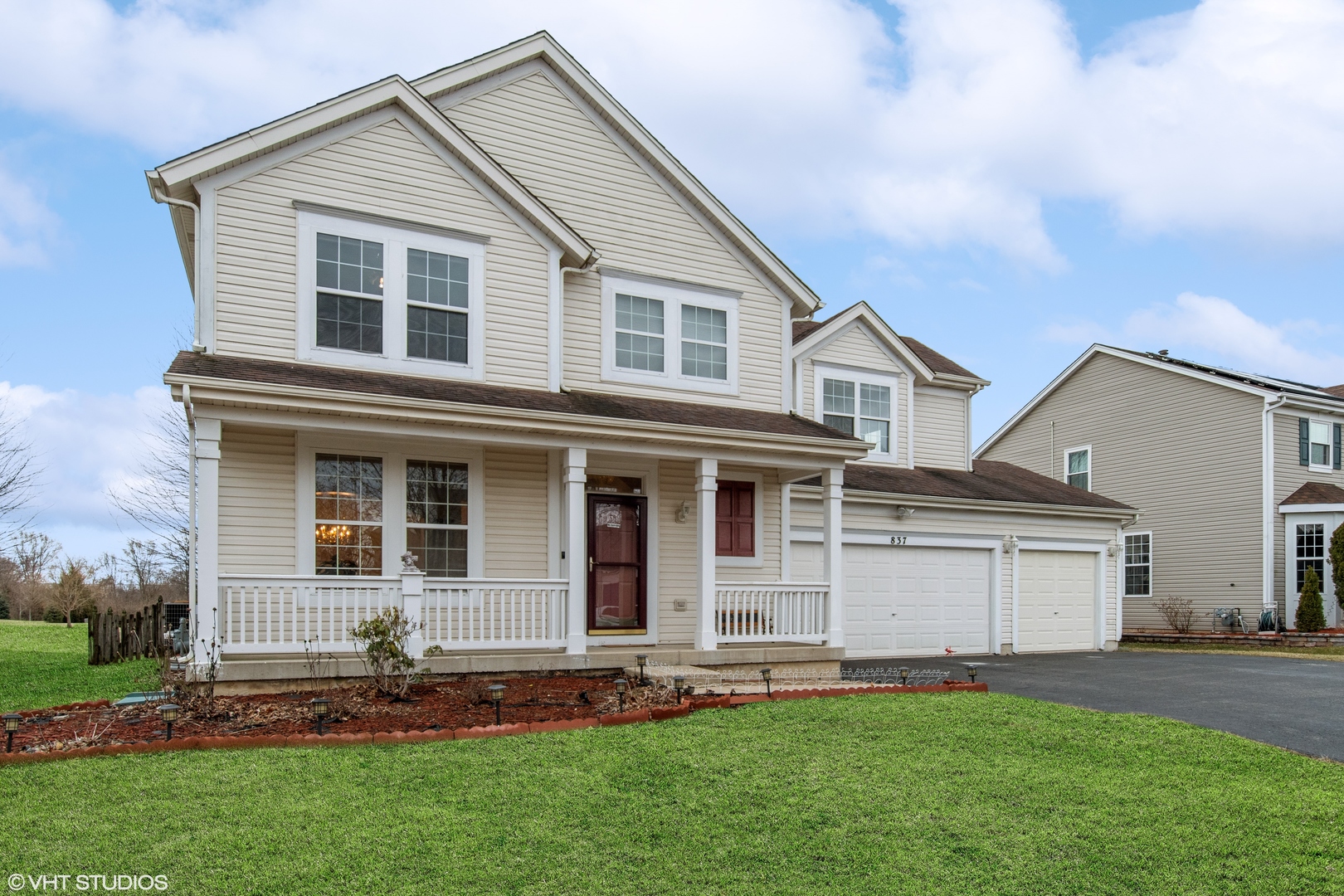 a front view of a house with a yard and garage