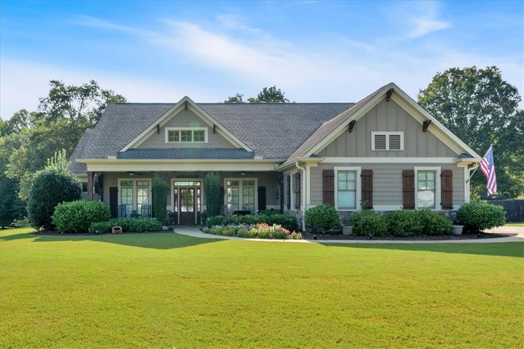 a front view of a house with porch and garden