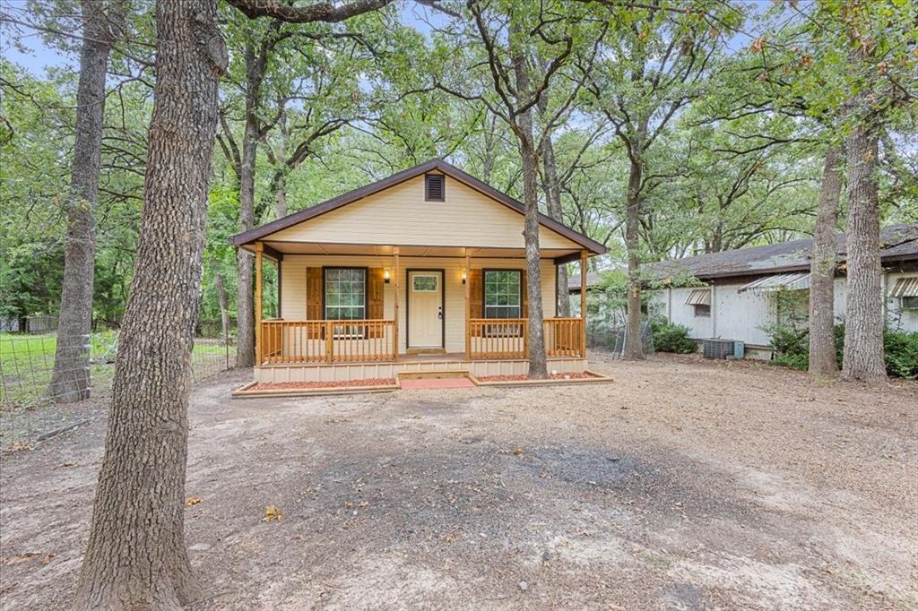 a view of a house with a tree in front of it