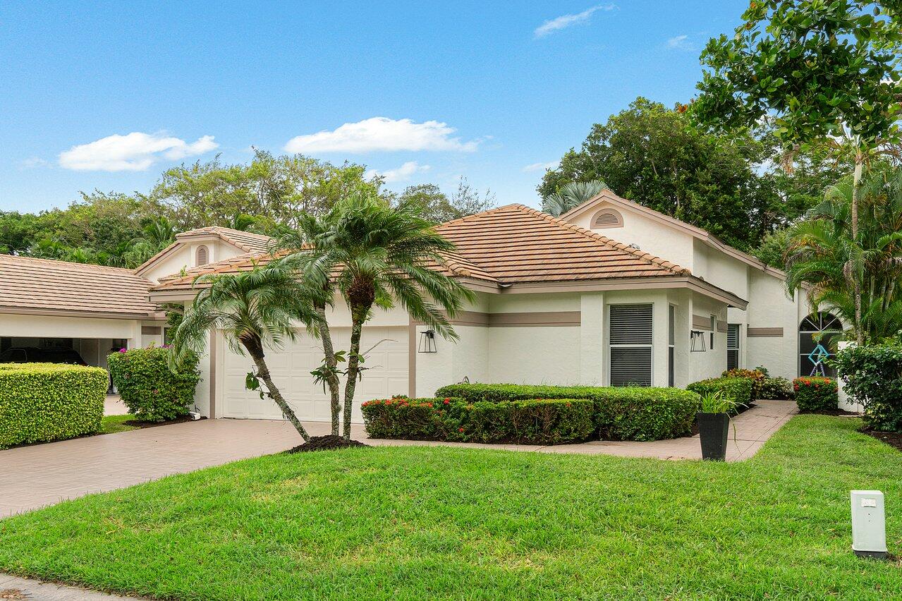 a front view of a house with a garden