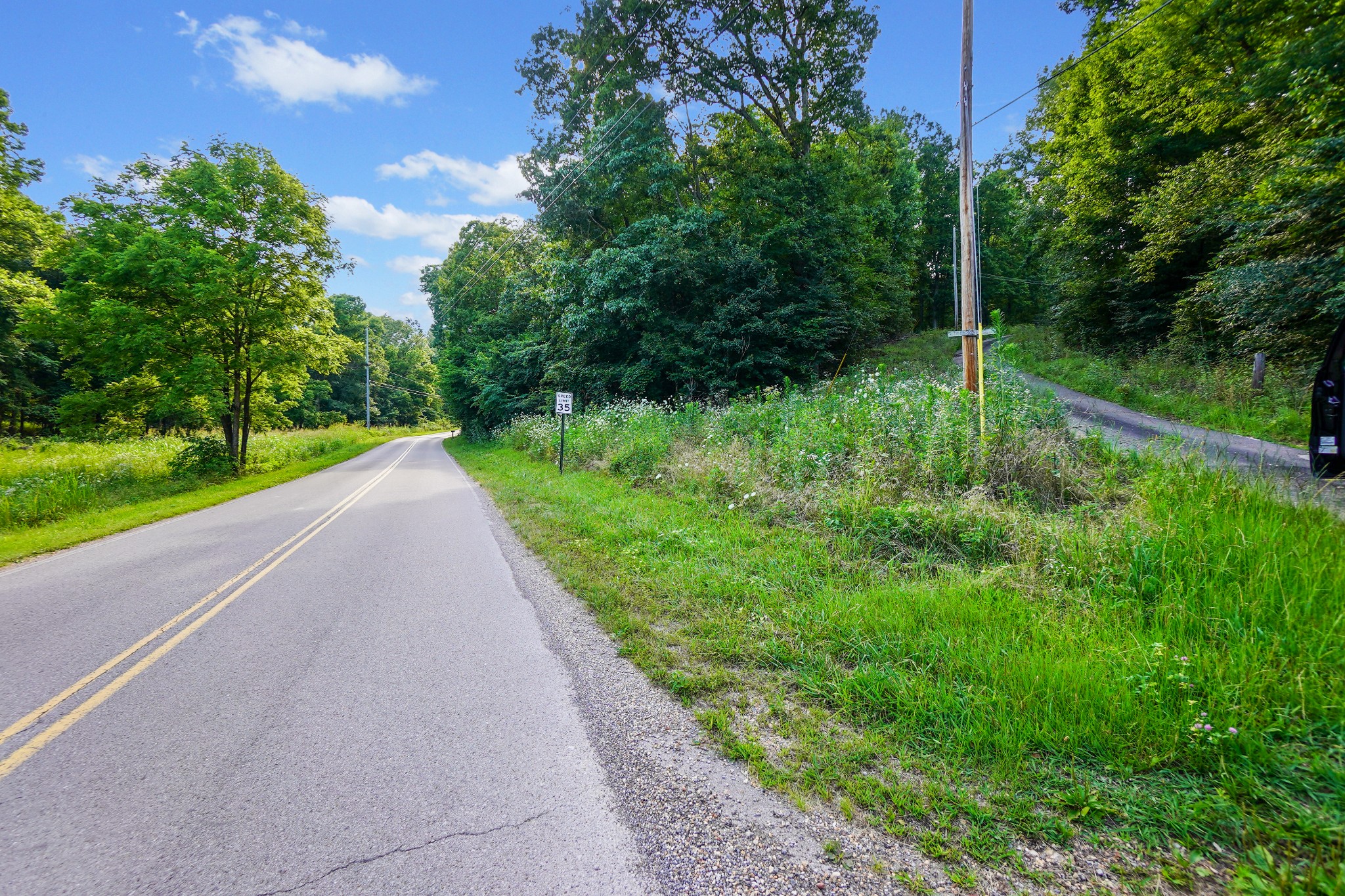 a view of a road with a yard