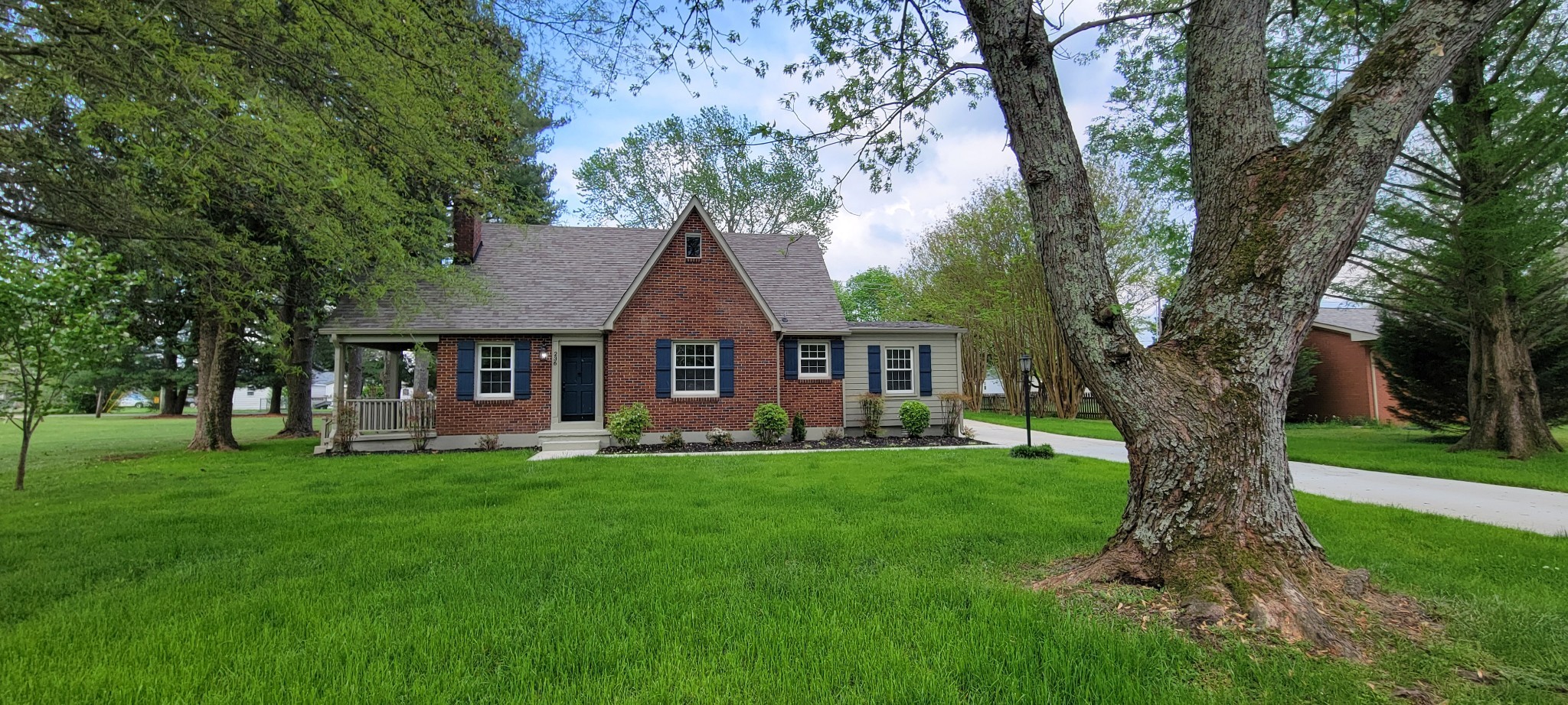 a front view of a house with a garden