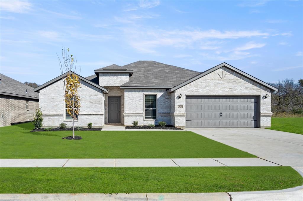 a front view of a house with a yard and garage