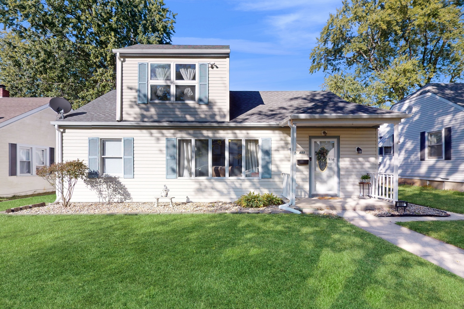 a front view of a house with garden and porch