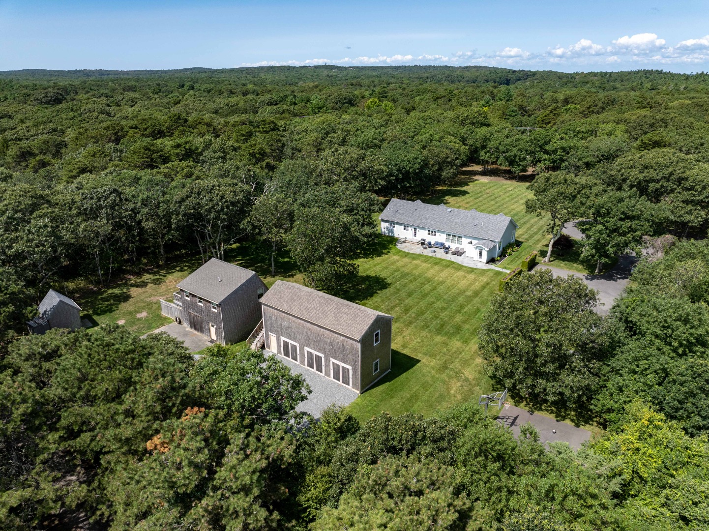 an aerial view of a house with a yard and lake view