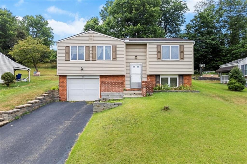 a front view of a house with a yard and garage