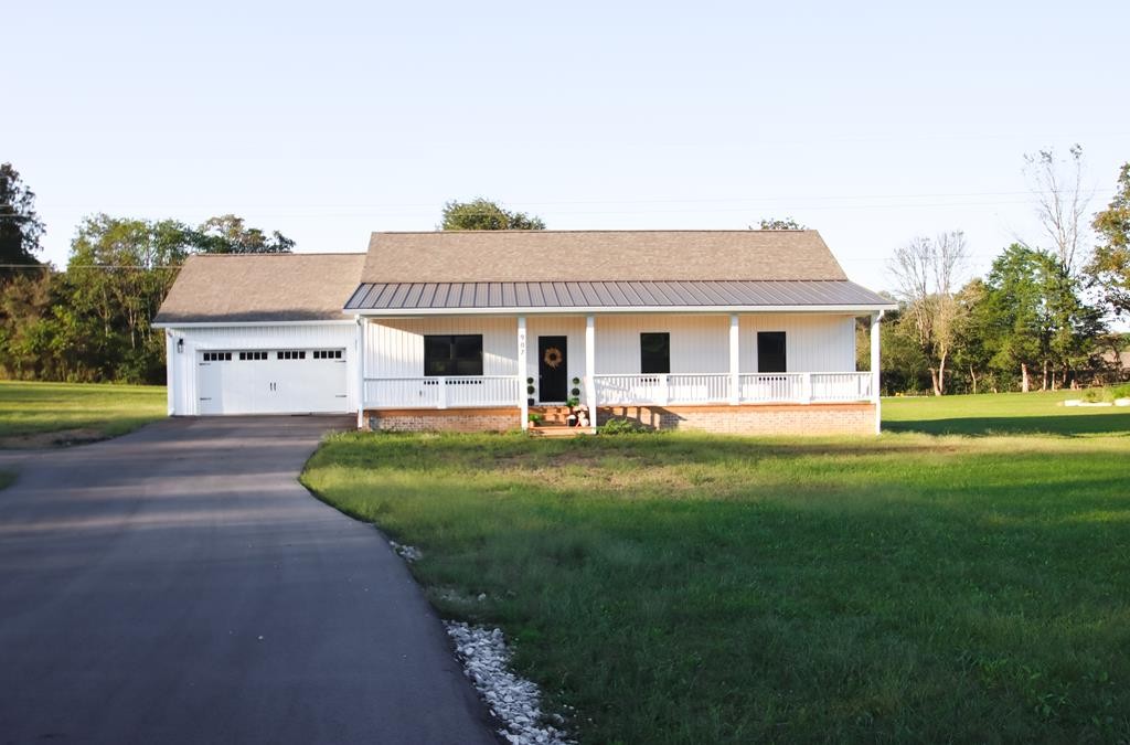 a view of a house with a backyard