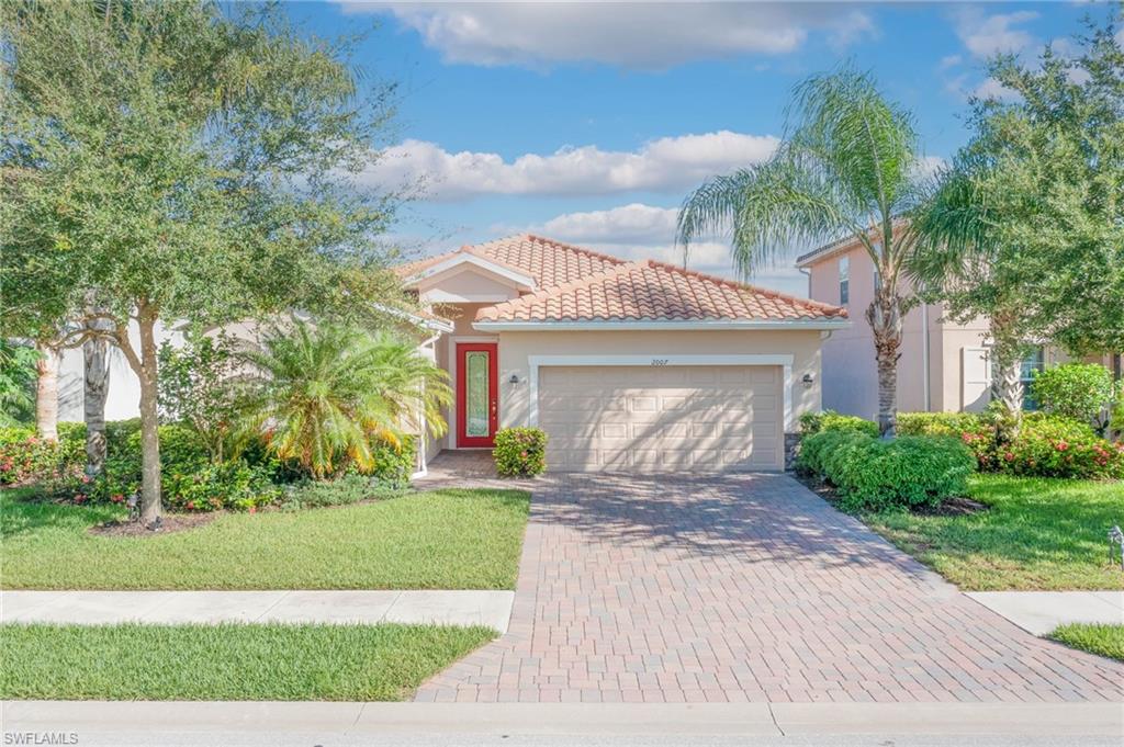 a front view of a house with a yard and garage