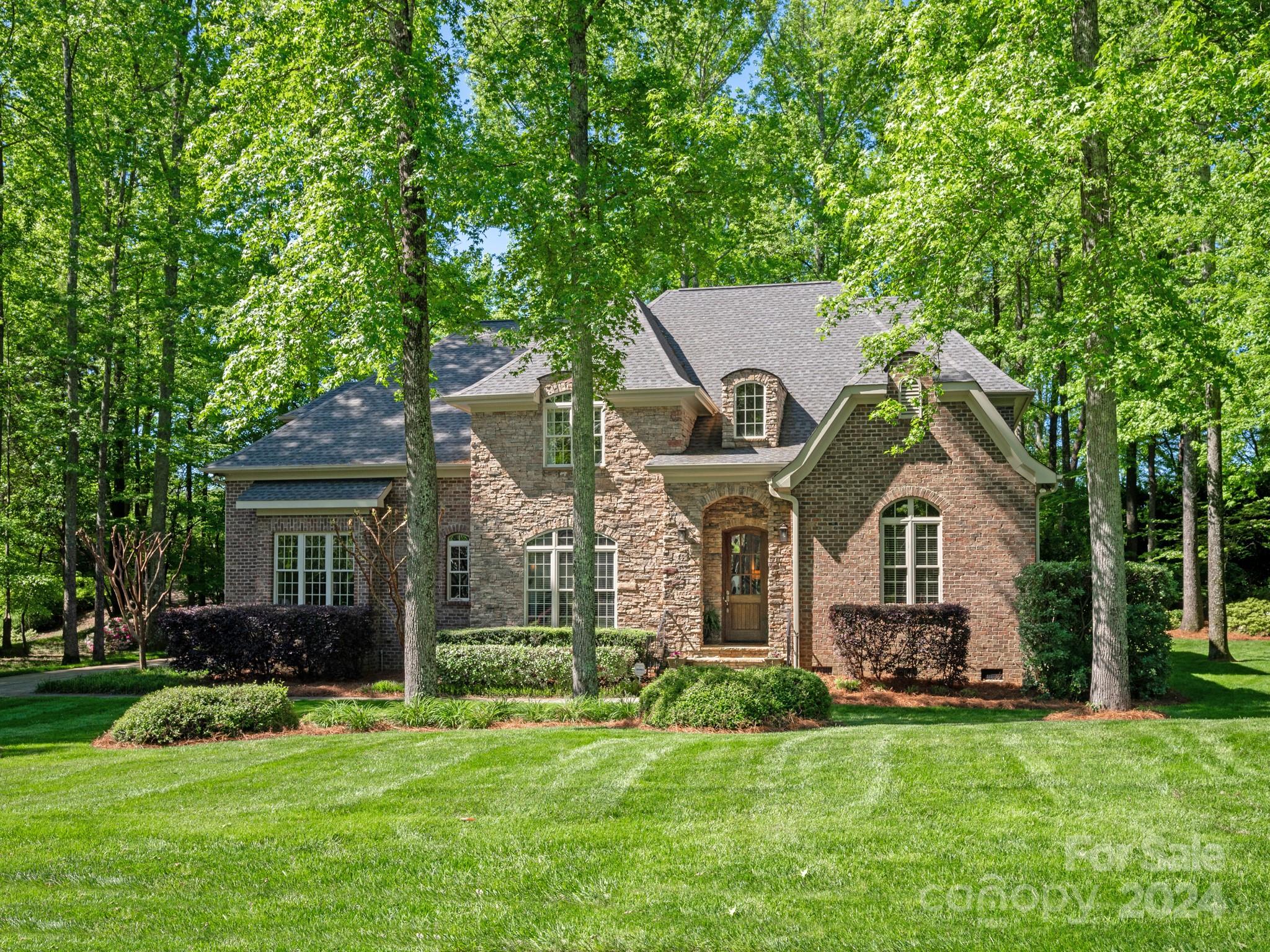 a front view of house with yard and green space