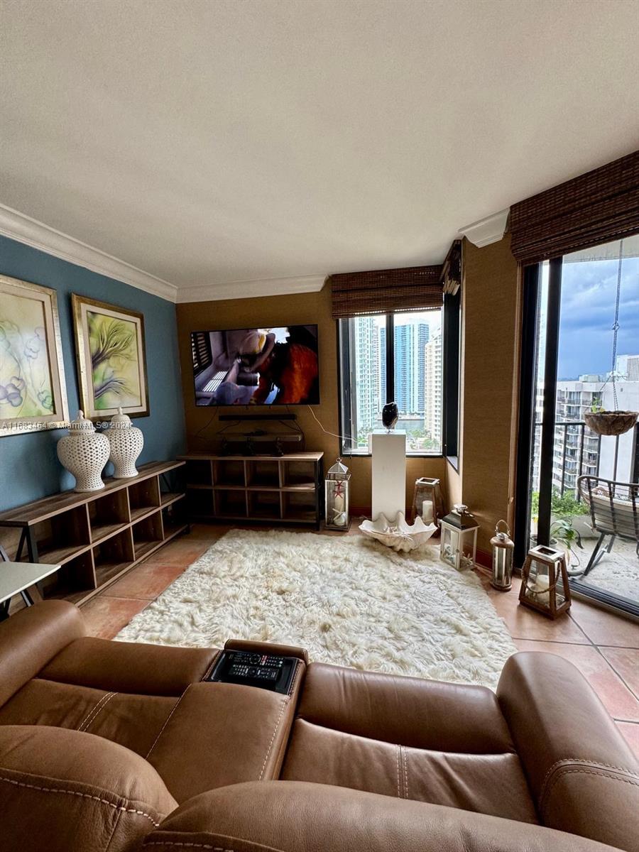 a living room with furniture window and a flat screen tv