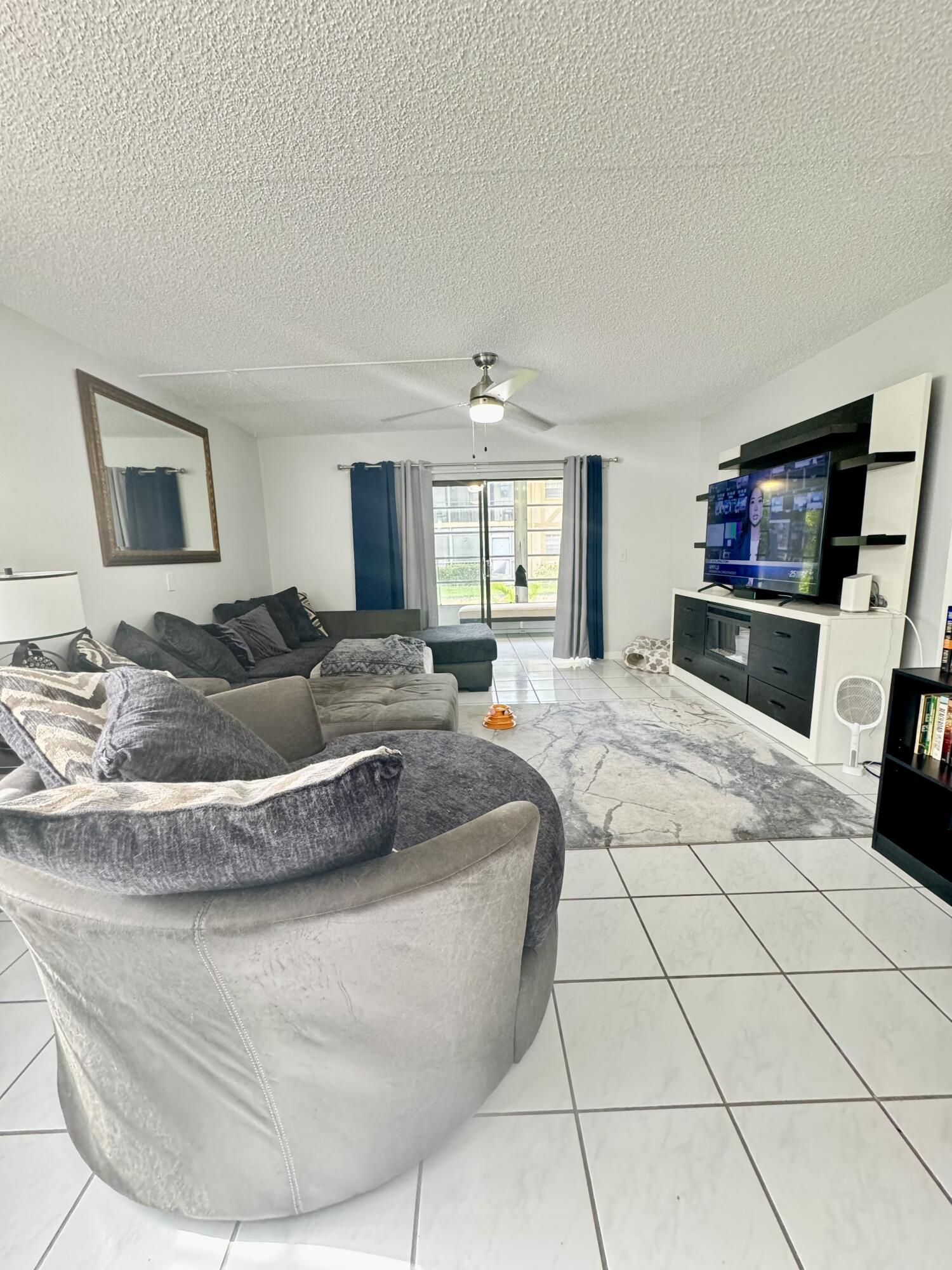 a living room with a bed and a flat screen tv