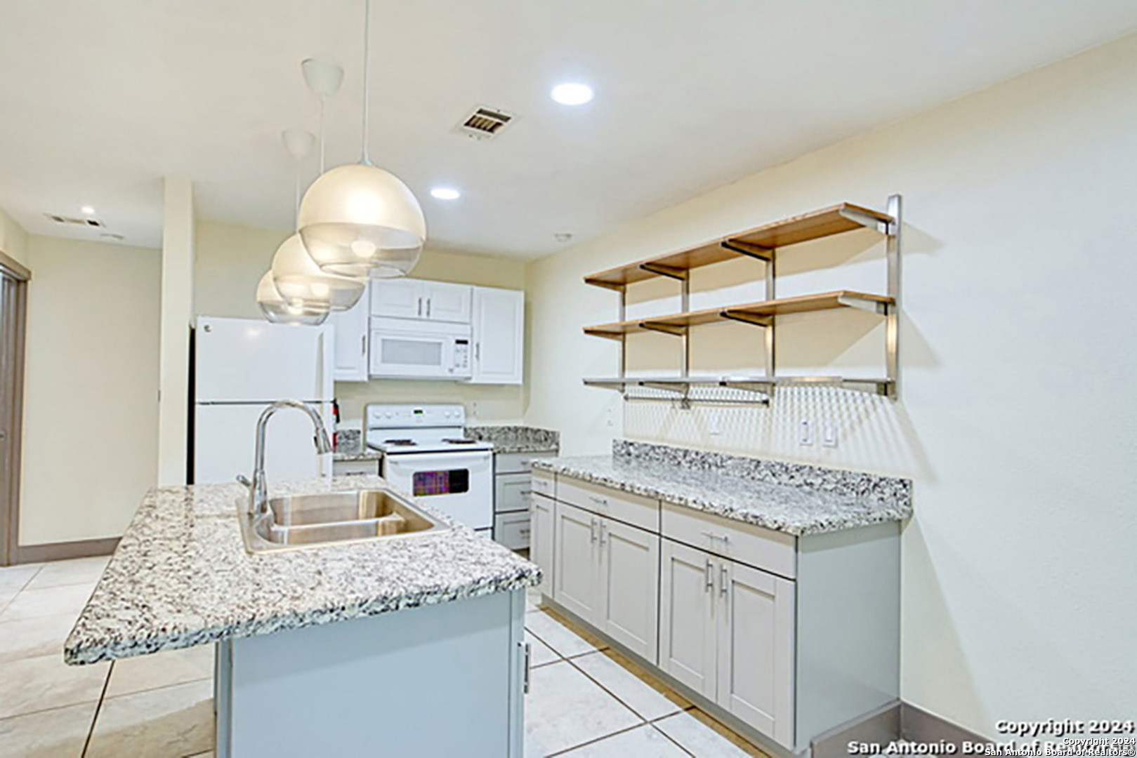 a kitchen with a sink stove and cabinets