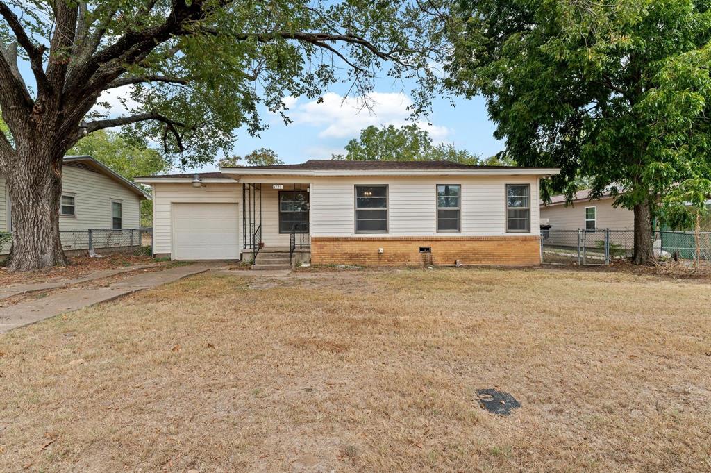 Ranch-style house with a garage and a front yard