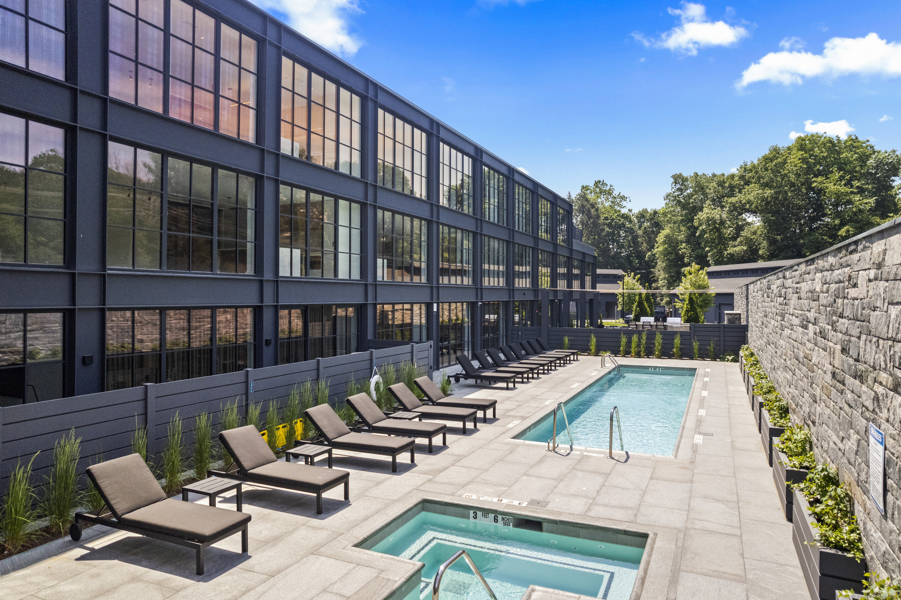 a view of swimming pool with seating area and furniture