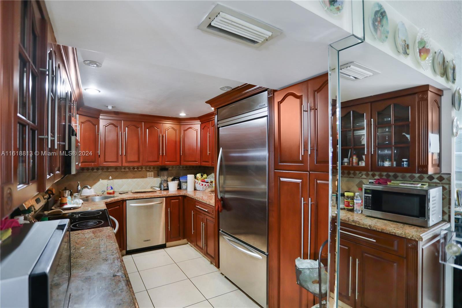 a kitchen with a sink stainless steel appliances a refrigerator and a sink