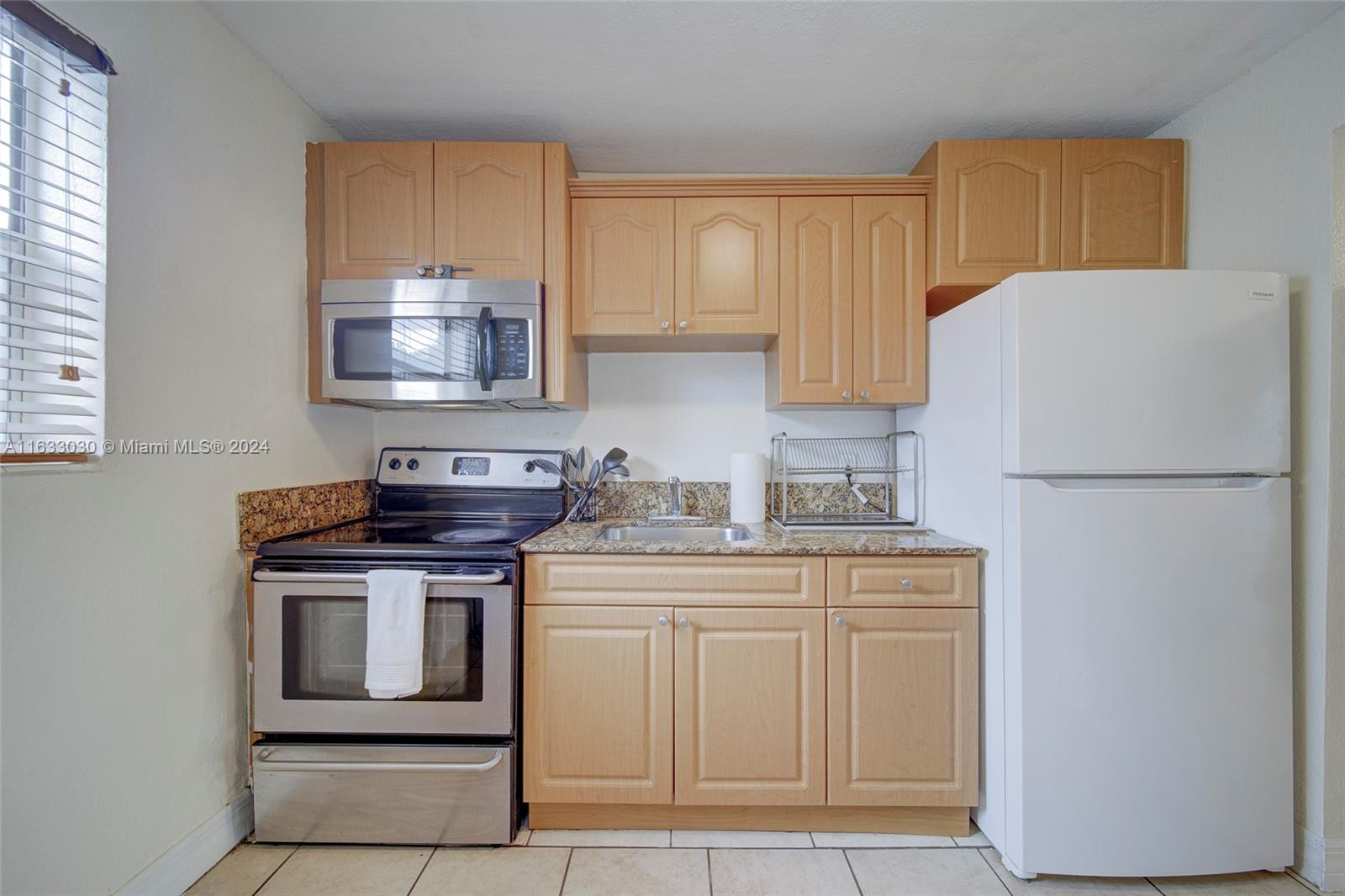 a kitchen with stainless steel appliances granite countertop a refrigerator stove a sink and dishwasher