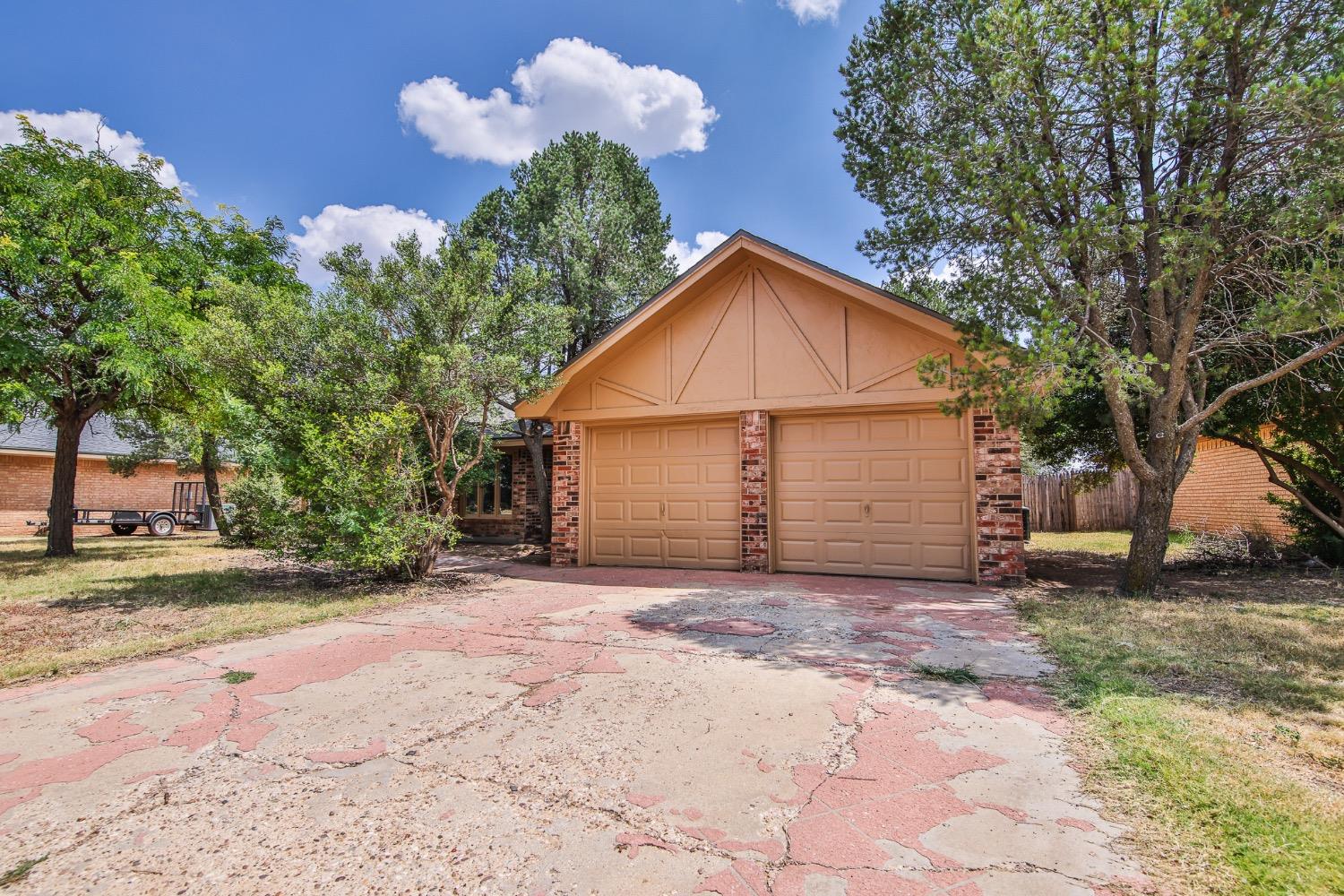 a view of a house with a yard and garage