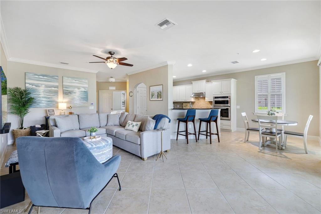 a living room with furniture and kitchen view