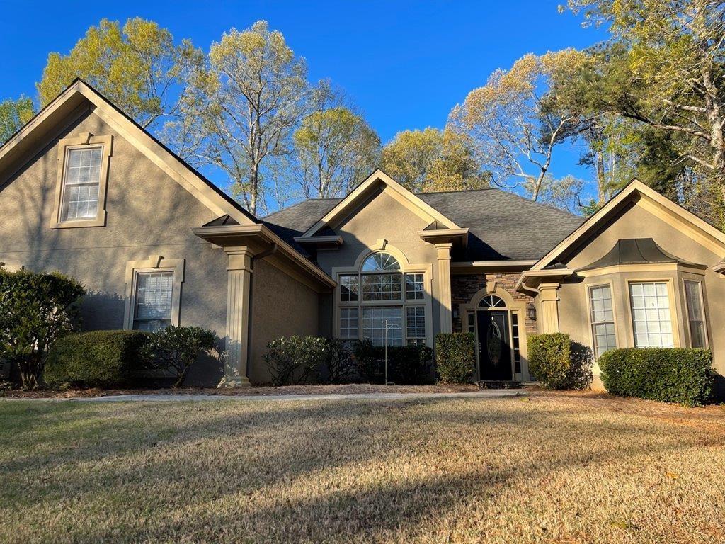 a front view of a house with a yard and garage