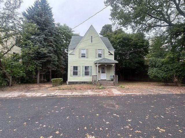 a view of a white house with a yard