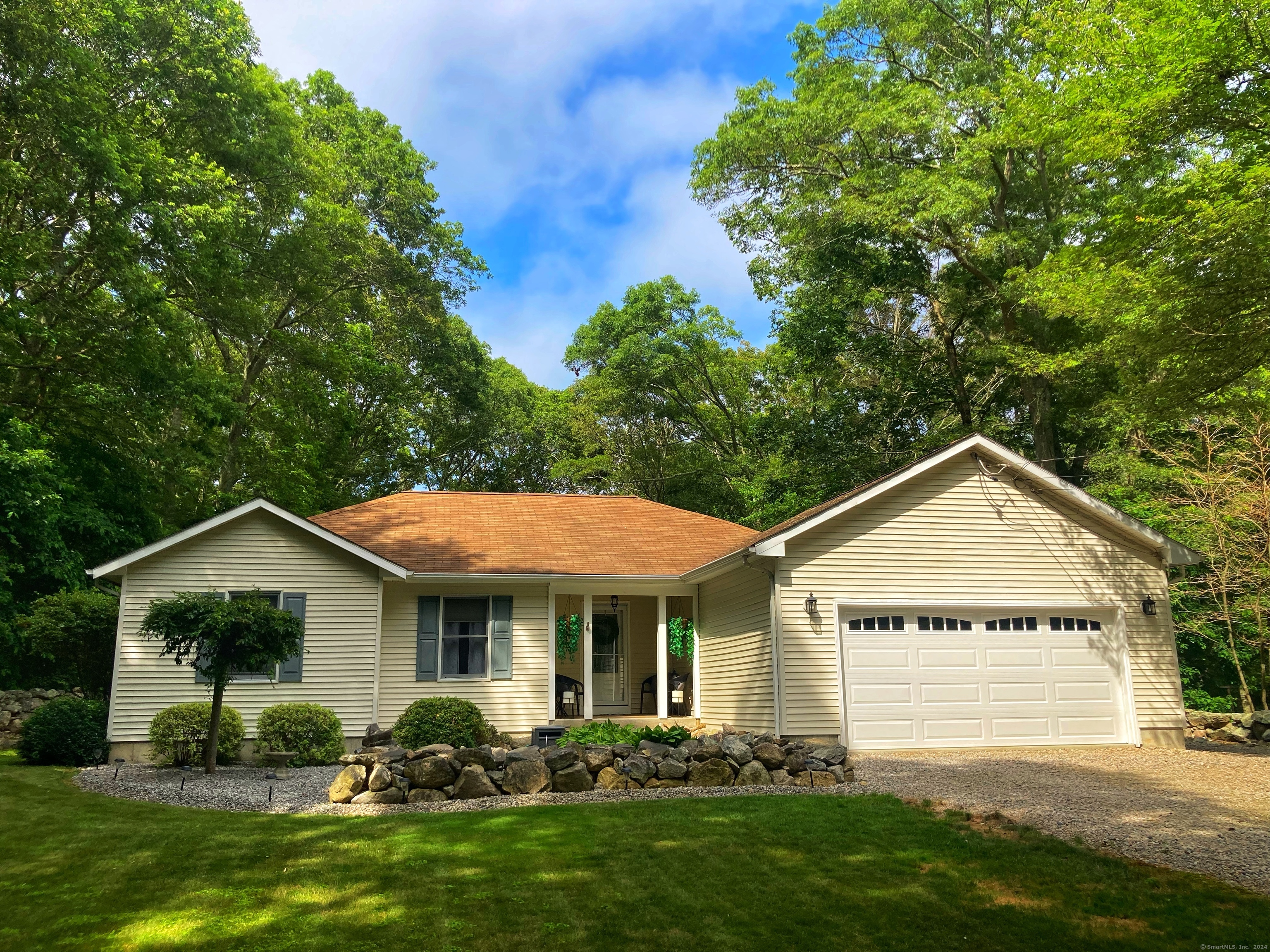 a front view of house with yard and green space