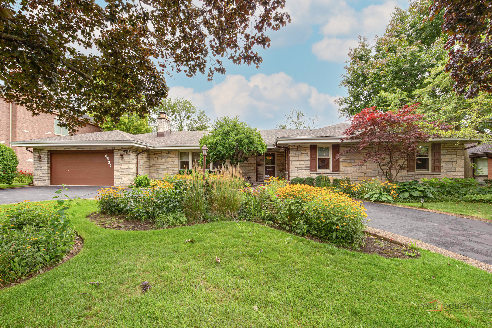 a front view of house with yard and green space