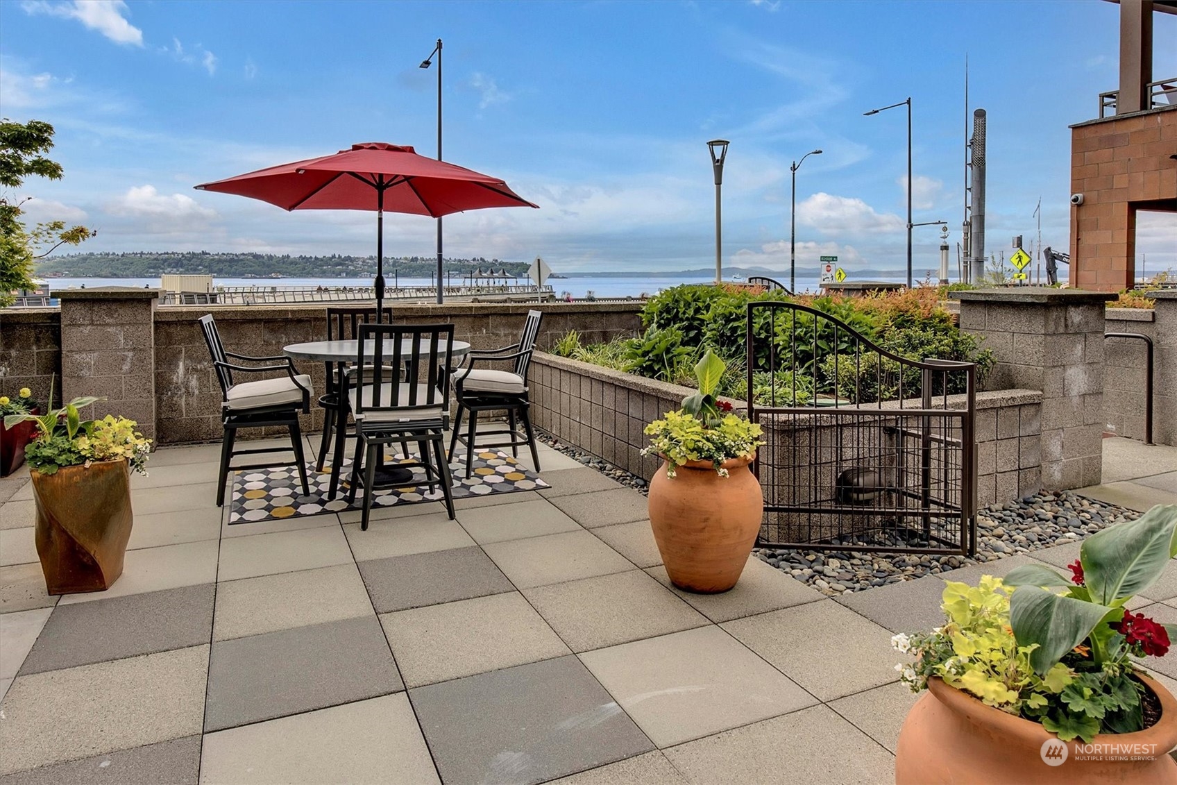 a patio with a table and chairs under an umbrella