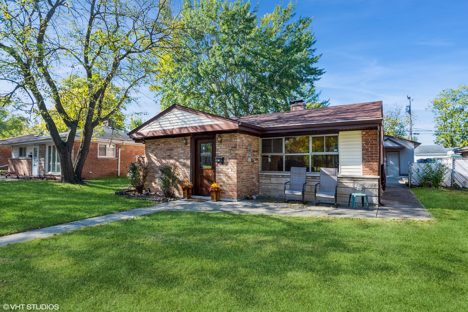 a view of a house with a yard and sitting area