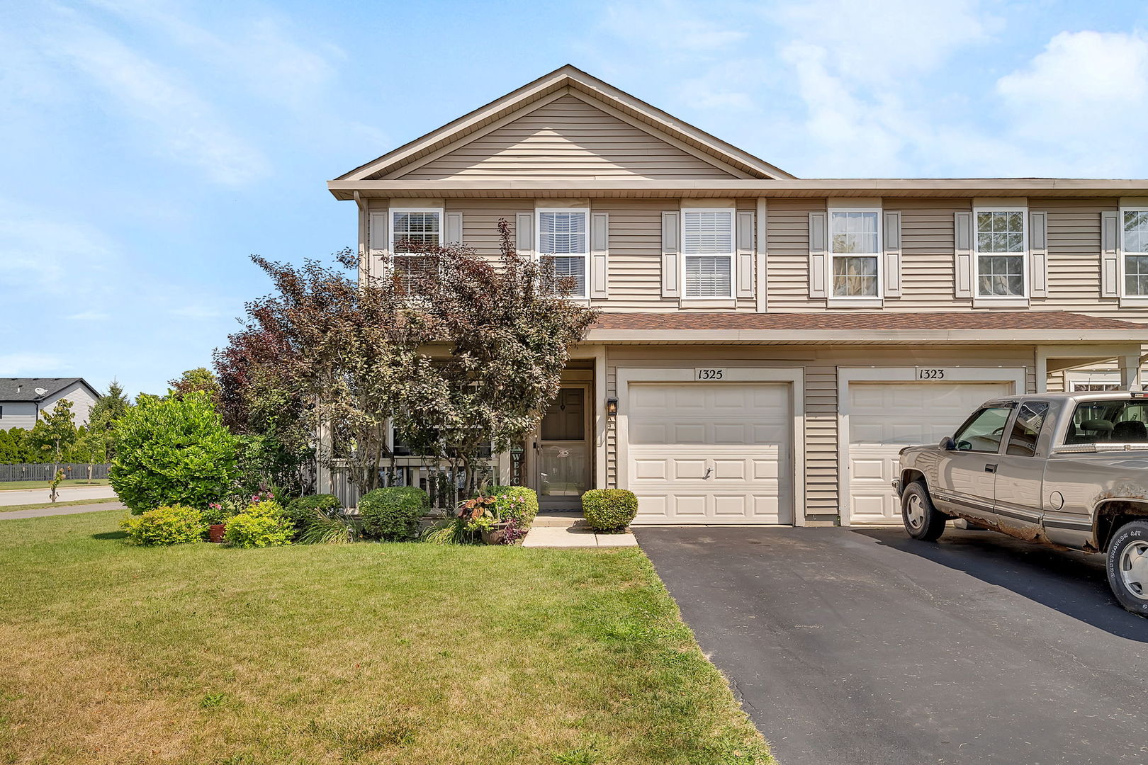 a front view of a house with a yard and garage