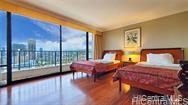 a bedroom with two beds and glass window