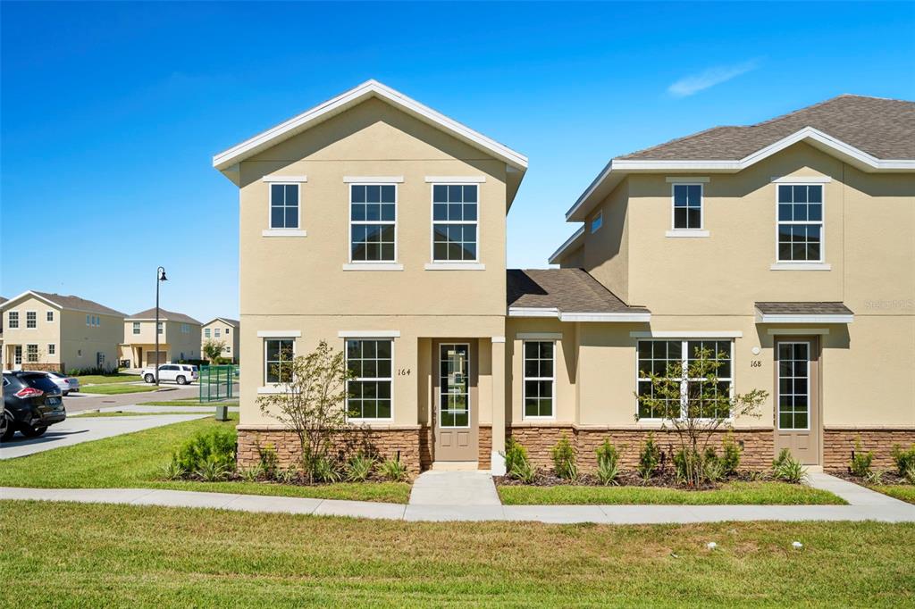 a front view of a house with a yard