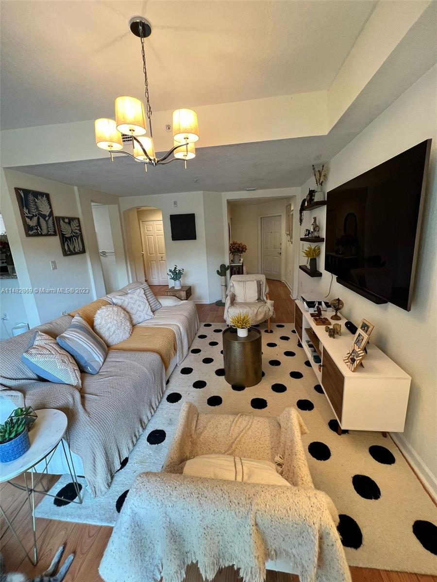 a bedroom with furniture and a flat screen tv