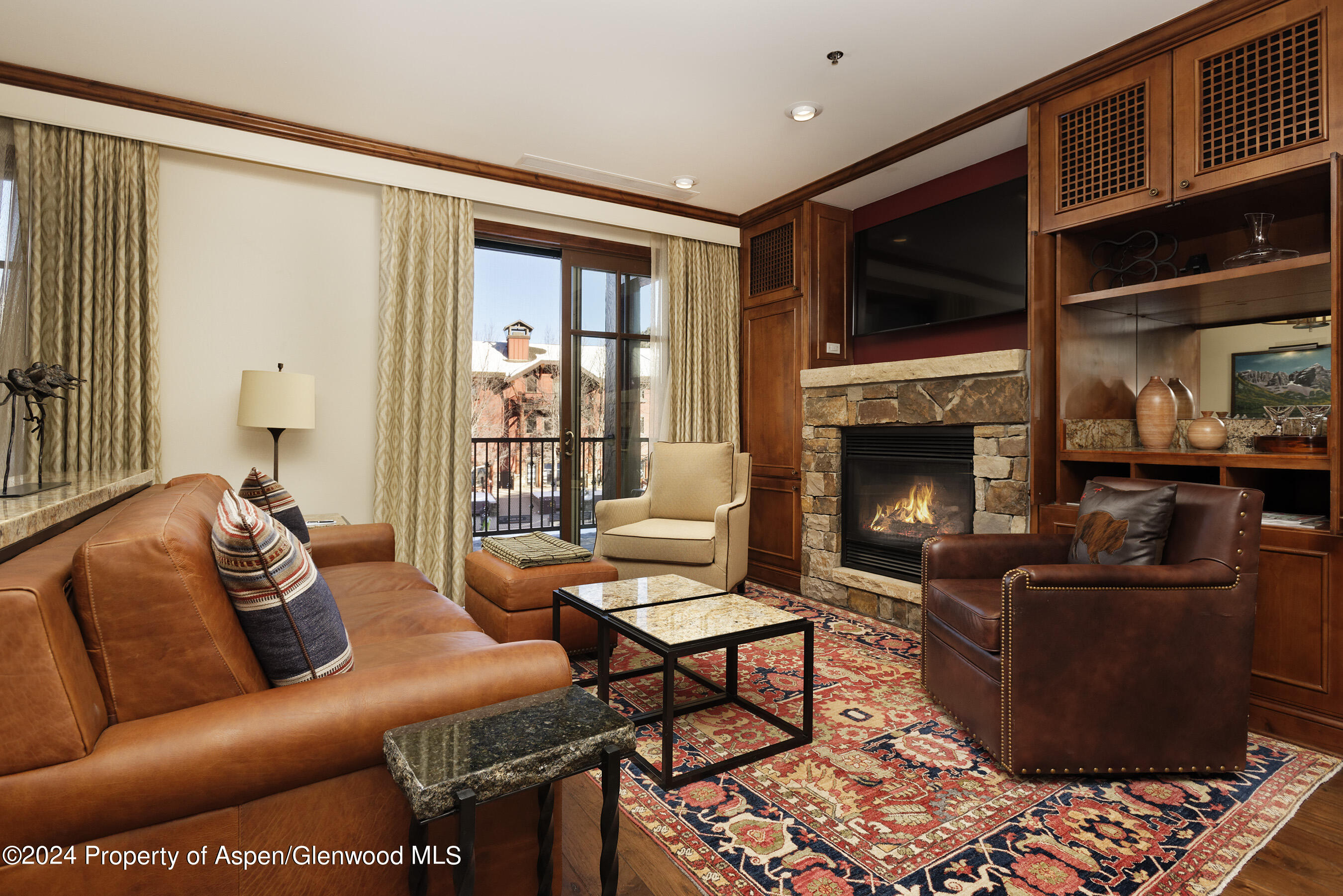 a living room with furniture fireplace and flat screen tv